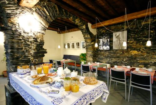 a dining room with a table with food on it at Villa Paggi Country House in Carasco