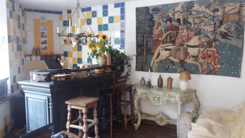 a living room with a table and a painting on the wall at Golden Lion in Bouillon