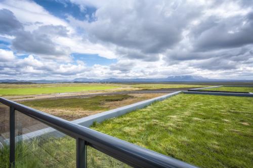 a view of a field from the balcony of a house at Hótel Laxá in Myvatn