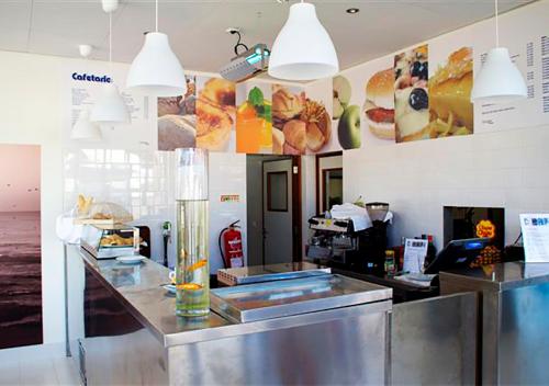a fast food restaurant with a counter with food at Parque de Campismo Orbitur Canidelo in Vila Nova de Gaia