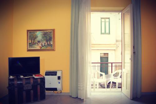 a living room with a door open to a balcony at Casa Vacanze Zia Titina in Trabia