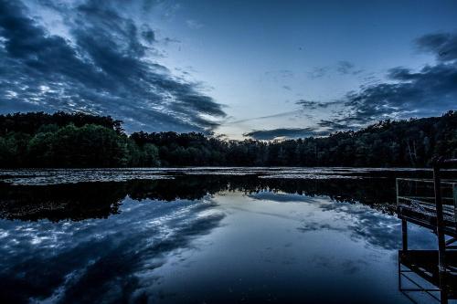 a large body of water with a cloudy sky at Waldsee Hotel am Wirchensee in Treppeln