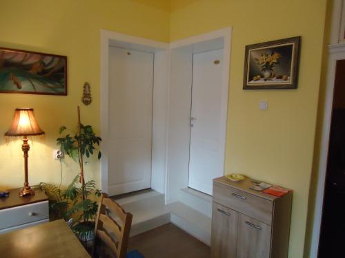 a room with a table and a desk and a door at Apartments Villa Svetlana in Vrnjačka Banja