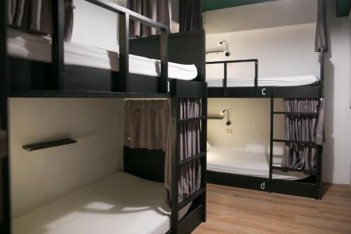 a group of bunk beds in a room at We Come Hostel in Taipei