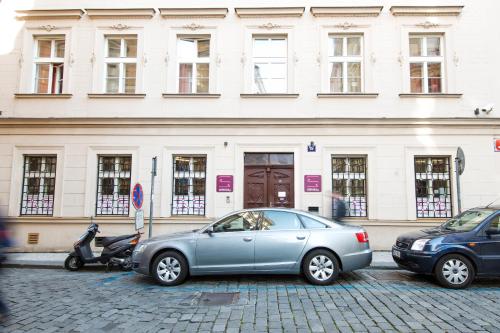 two cars parked in front of a building at Safestay Prague Charles Bridge in Prague