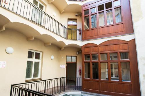 an external view of a house with wooden doors and a balcony at Safestay Prague Charles Bridge in Prague