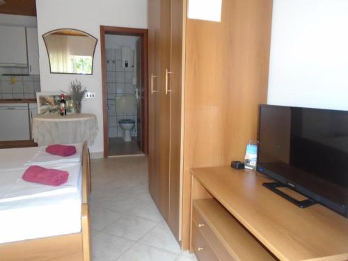 a living room with a flat screen tv on a table at Apartments Sveti Anton in Orebić