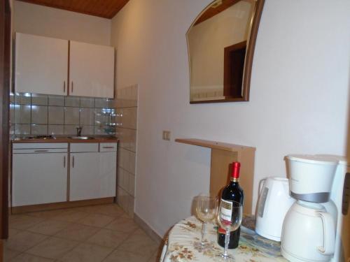 a kitchen with a bottle of wine on a table at Apartments Sveti Anton in Orebić