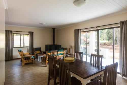 a living room with a wooden table and chairs at Kamberg Valley Hideaway in Kamberg Valley