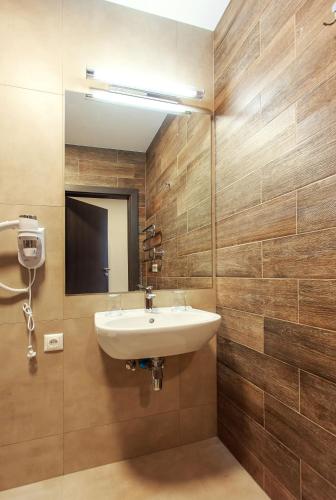 a bathroom with a sink and a mirror at Old Town Trio Apartments in Vilnius