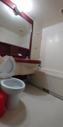 a bathroom with a toilet and a sink and a tub at Seoraksan BanDalGom in Sokcho