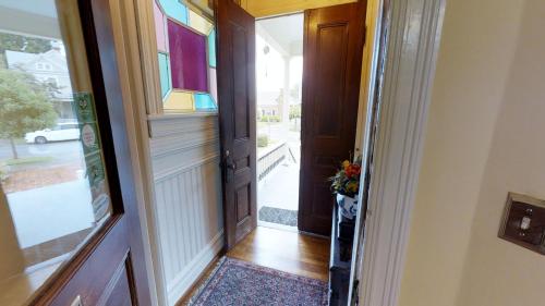 an open door with a vase of flowers in a hallway at Hanna House Bed & Breakfast in New Bern