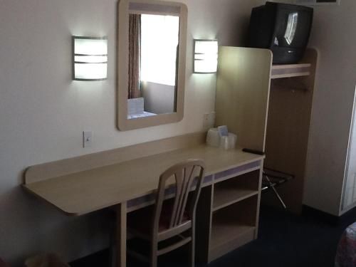 a bathroom with a vanity with a mirror and chairs at Motel 6-Nephi, UT in Nephi