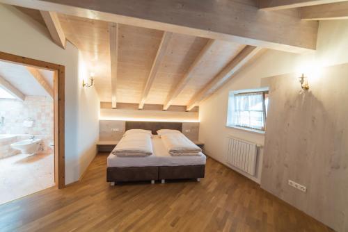 a large room with two beds and a bathroom at Jagerhof in Caldaro