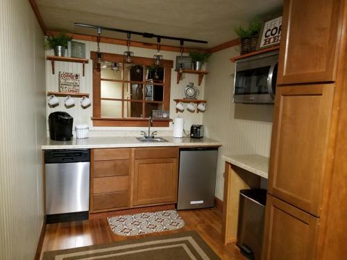 a kitchen with a sink and a stove at Hocking Hills Inn in Logan