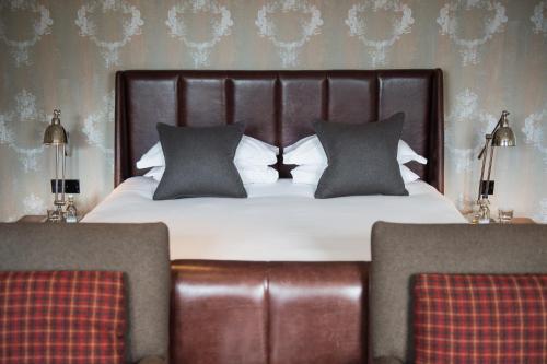 a bedroom with a large bed with black and white pillows at Hotel Du Vin & Bistro Tunbridge Wells in Royal Tunbridge Wells