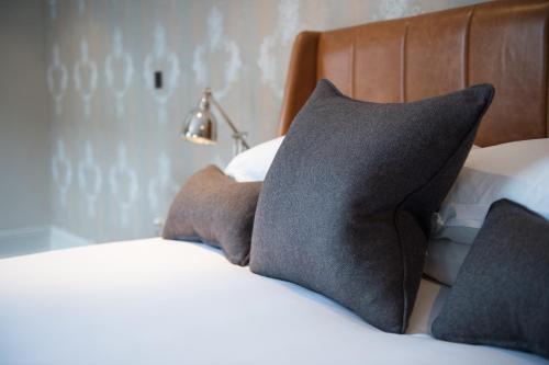 a bed with two pillows on top of it at Hotel Du Vin & Bistro Tunbridge Wells in Royal Tunbridge Wells