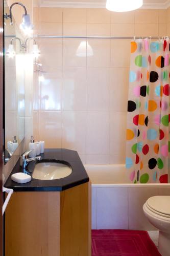 a bathroom with a sink and a tub and a shower at Porto RT in Rio Tinto