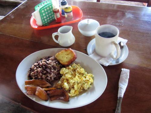a plate of breakfast food with a cup of coffee at Caballito's Mar in Ometepe