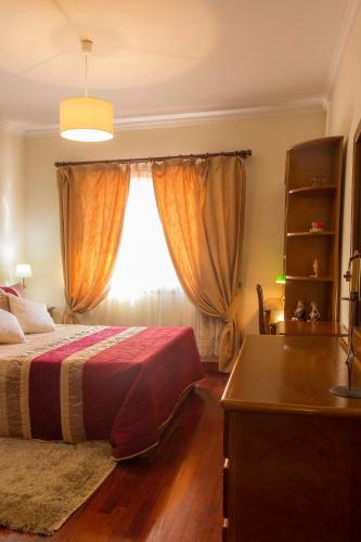 a bedroom with a bed and a window at Porto RT in Rio Tinto