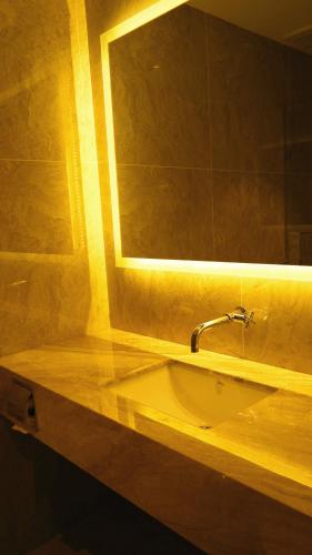 a bathroom with a sink and a mirror at Hotel Legend Boutique in Johor Bahru