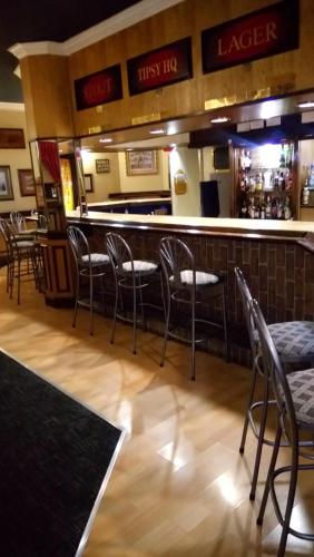 a bar in a restaurant with chairs and a counter at Royal Hotel Ladysmith in Ladysmith