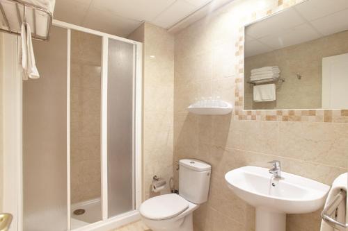a bathroom with a toilet and a sink and a shower at Hostal Mar y Huerta in Es Cana