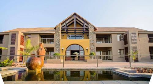 a building with a fountain in front of it at Nkomazi Kruger Lodge & Spa in Malelane