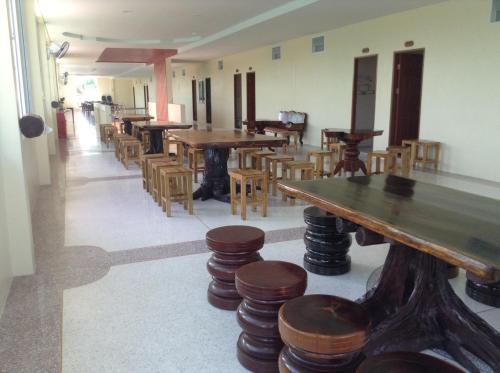 a room with wooden tables and chairs and a pool table at Khong Chiam 2 Hotel in Khong Chiam