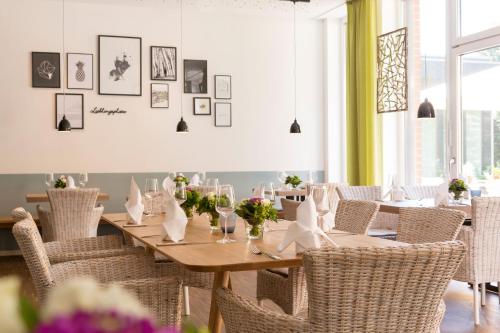 a dining room with a wooden table and chairs at Steverbett Hotel in Lüdinghausen