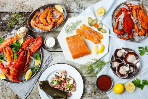 a table topped with plates of seafood and other foods at Hotel Legend Boutique in Johor Bahru