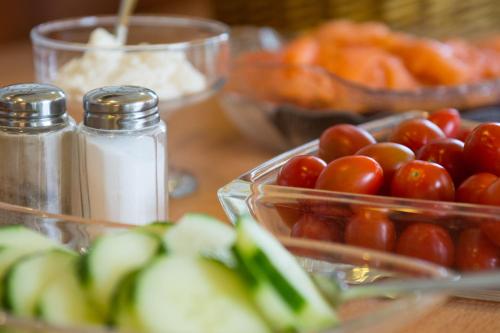 a table topped with containers of tomatoes and other ingredients at Hotel Casa Rustica - Eintrittskarten für den Europapark erhalten Sie garantiert über uns! in Rust