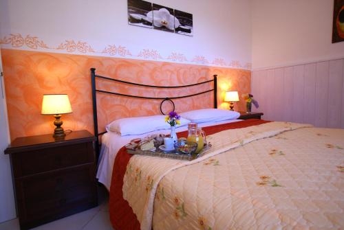 a bedroom with a large bed with two lamps at Il Querceto in Bosco