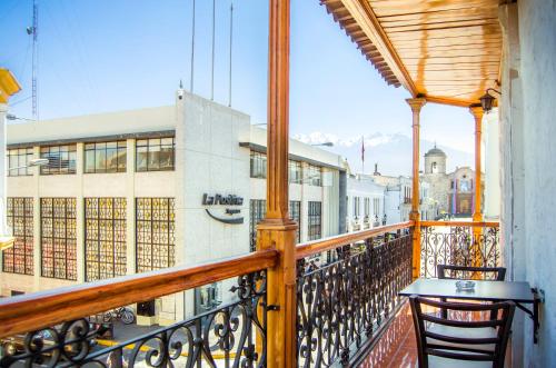 a balcony with a table and chairs on a building at Le Foyer Arequipa in Arequipa