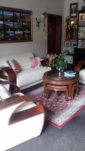a living room with a couch and a coffee table at Mulligans Guest Lodge in Hermanus