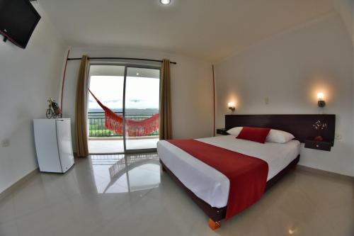 a bedroom with a large bed and a large window at Hotel Montserrat Plaza in Monterrey