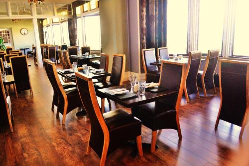 a dining room with tables and chairs in a restaurant at Stotfield Hotel in Lossiemouth