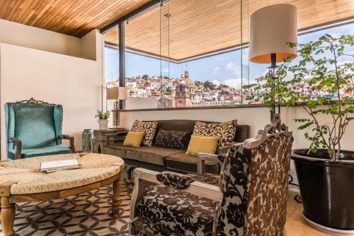 a living room with a couch and a table at Edelmira Hotel Boutique in Guanajuato