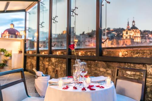 a table in a restaurant with a view of the city at Edelmira Hotel Boutique in Guanajuato