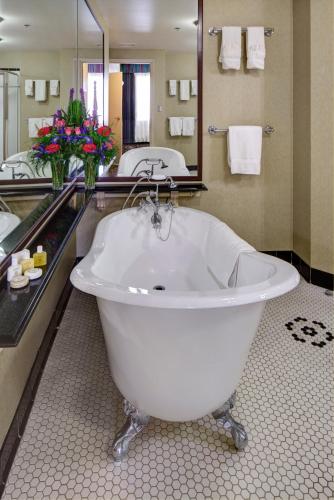 a large bathroom with a tub and a large mirror at Carnegie Hotel & Spa in Johnson City