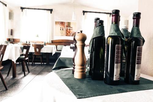 four bottles of wine sitting on a table with a chessboard at Gasthof zum Richter in Mühldorf
