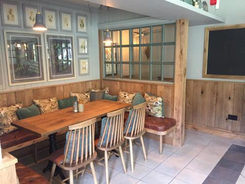 a dining room with a wooden table and chairs at Victoria Inn in Llanbedr