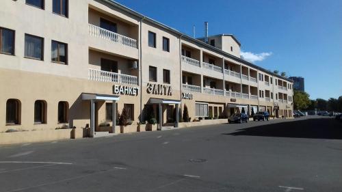 a large building with a parking lot in front of it at Hotel Elita in Odesa
