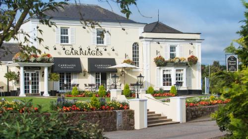 a white building with flowers in front of it at The Devon Hotel in Exeter