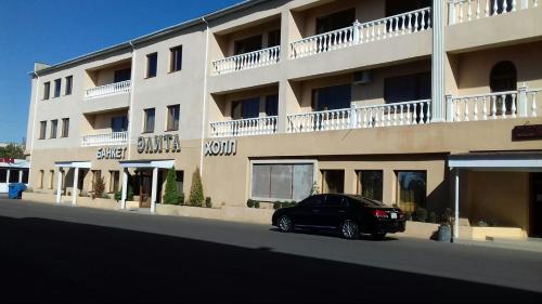 a black car parked in front of a building at Hotel Elita in Odesa