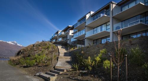 a building on the side of a hill with stairs at QS Lakeside Gem in Queenstown