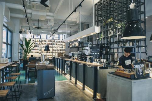 a man standing at a counter in a restaurant at Hotel Potmum Sapporo in Sapporo