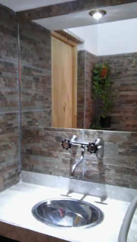 a bathroom with a sink and a mirror at Cabañas Casa de colores in Maimará