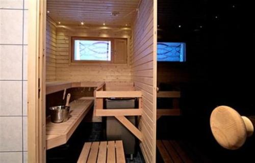 a small kitchen in a tiny house with a sink at Särkijärven Majat in Muonio