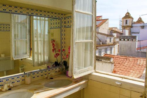 a bathroom with two sinks and two windows at Casa De S. Tiago in Évora